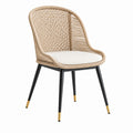 Fauteuil contemporain en rotin synthétique beige, métal noir, embouts dorés et coussin blanc, 58 x 60 x 85 cm